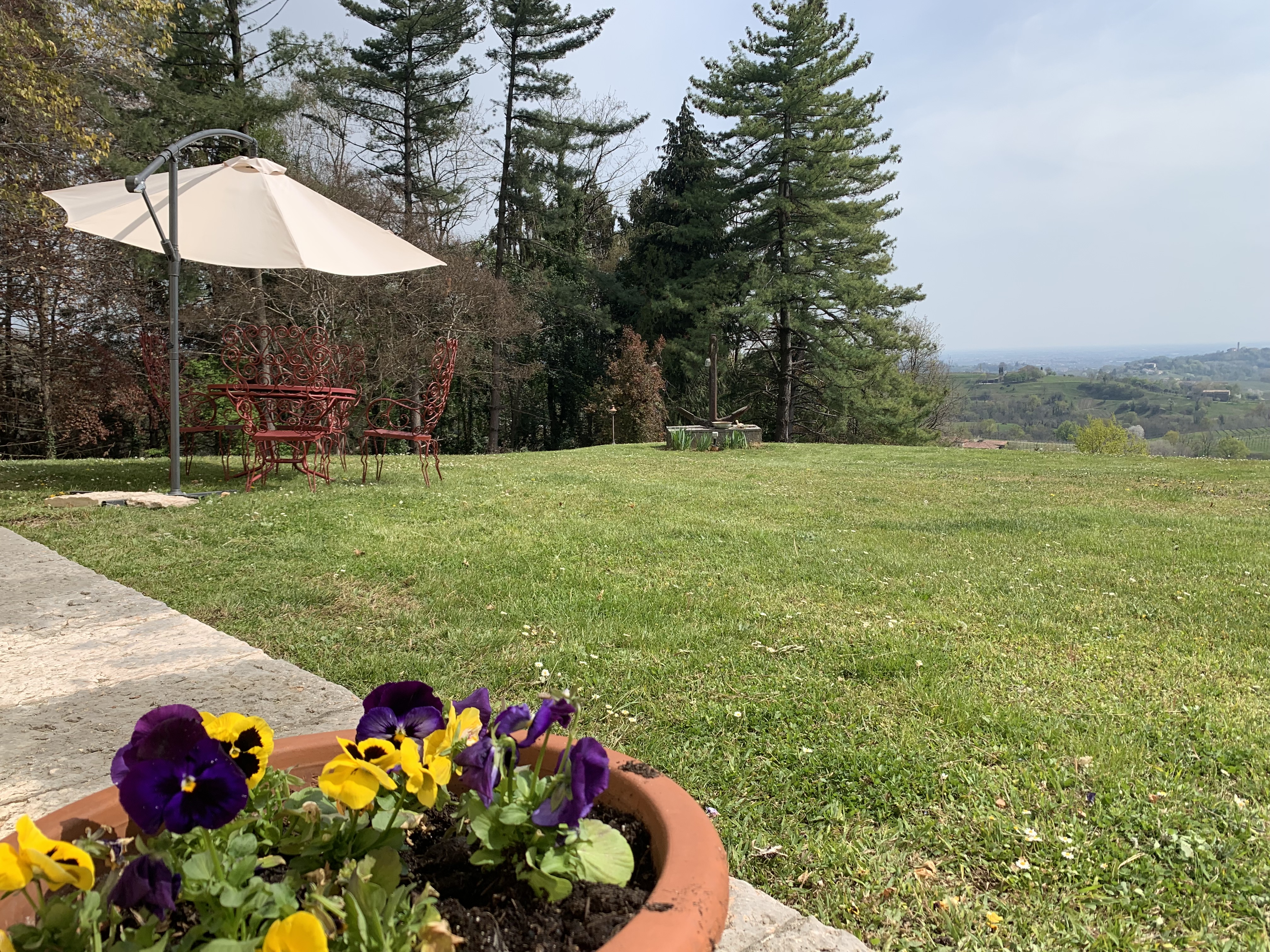 Garden La Torre di Rua - outdoor seating pansies panoramic view Prosecco Hills Treviso Italy